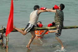 The one remaining on the pole wins in this traditional boxing game.